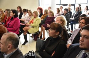 a group of people are listening to a lecture