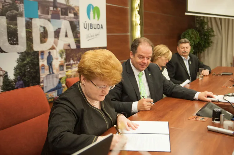 a woman is signing a document
