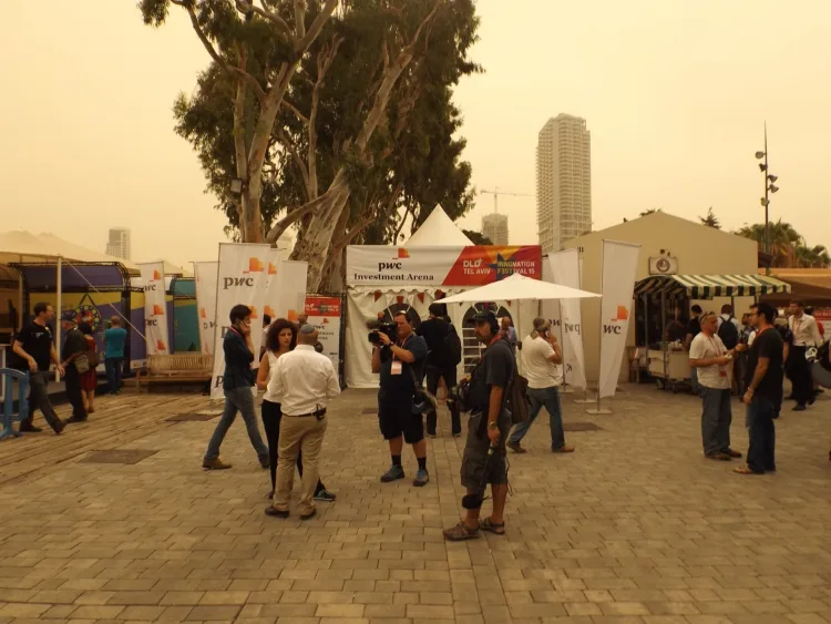 a group of people are giving interviews on the streets of tel aviv