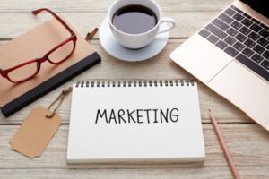 coffee, laptop and glasses on a table and a journal