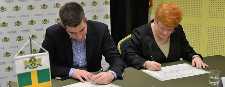 a man and a woman sign certificates