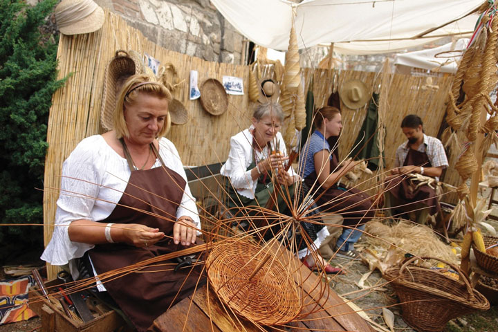 a group of people making hand made wooden specialities