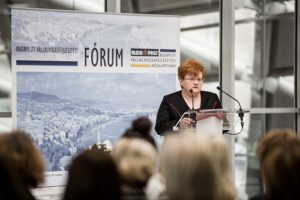 a middle aged woman is giving a speech