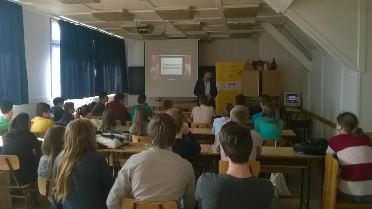 a middle aged man is giving a lecture